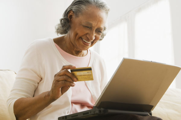 Senior African woman online shopping